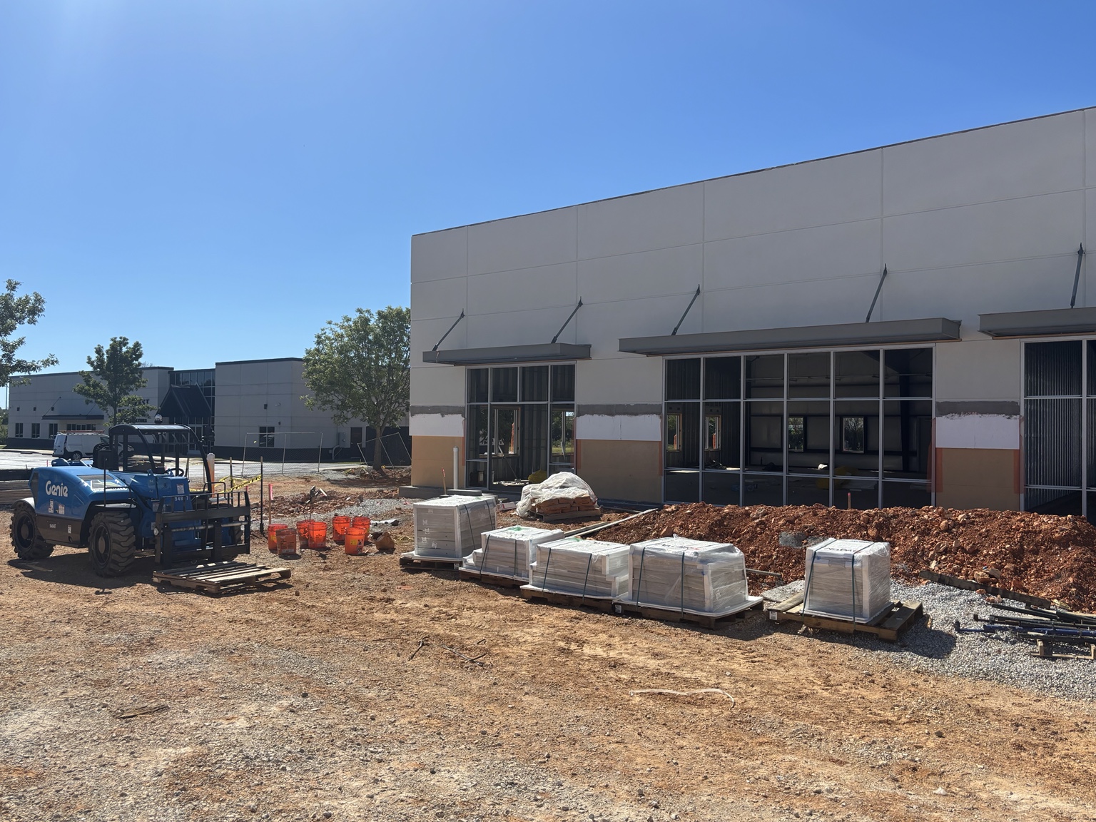 New NABOR commercial lease building under construction with the original headquarters behind it