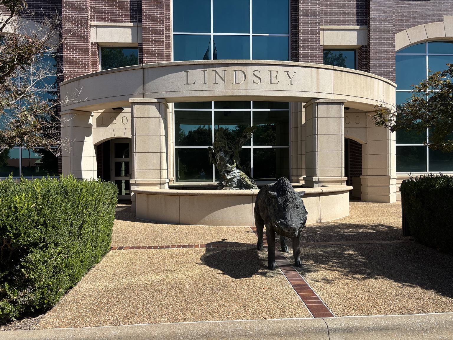Main Lindsey building entrance for Fugitt + Wheeler visitors, with curved sign and fountain at 1200 E. Joyce Boulevard